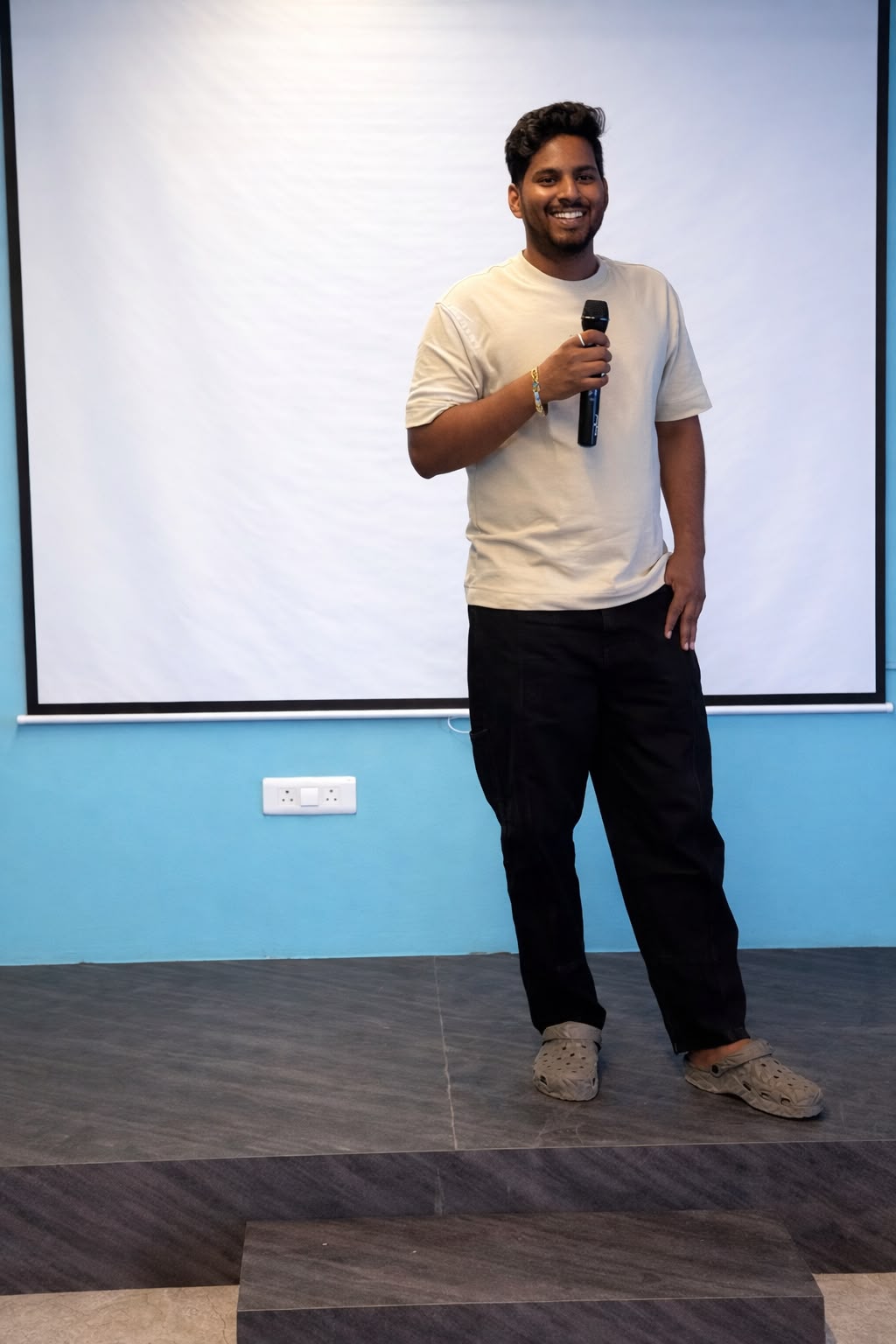 Coach Sreenivas Paturi teaching on stage with microphone