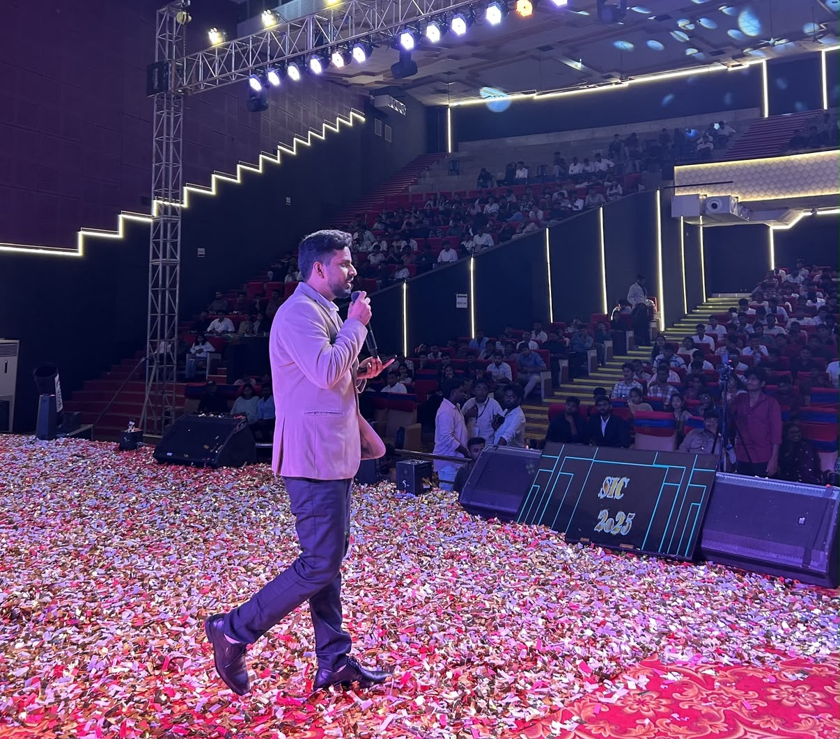 Coach Sreenivas Paturi speaking on stage at SIC 2025